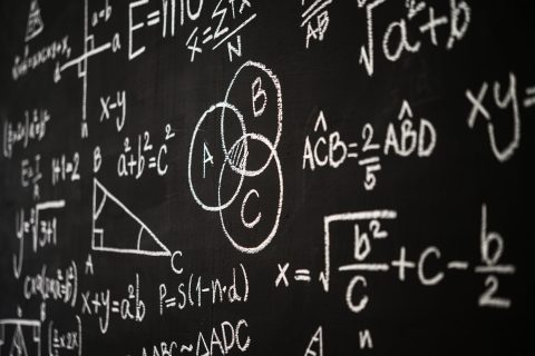 Blackboard inscribed with scientific formulas and calculations i