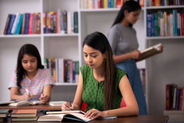 Female students studying in a modern library