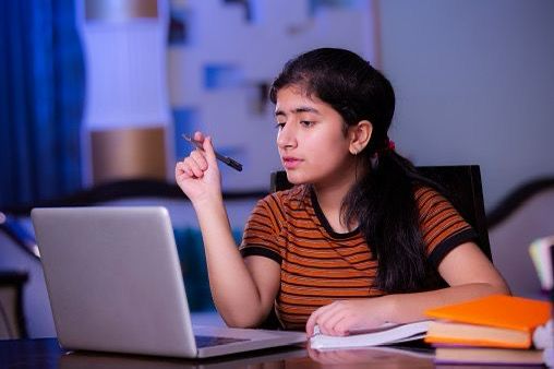 A collection of Gitam Junior College student rank posters highlighting top scorers, junior achievers, and a student studying with focus using a laptop.